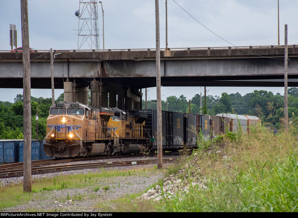 A southbound freight begins to crawl out of Riverfront Yard